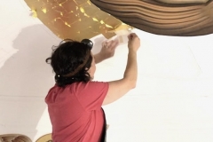 Below Khouriye Heather is adding the gold leaf squares that form the halo of Christ.
